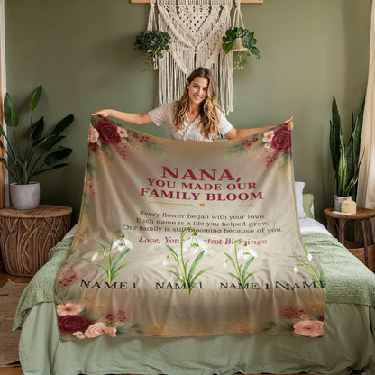 Personalized Nana birth flower blanket held in a warm bedroom