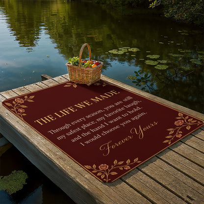 The Life We Made anniversary blanket displayed beside a peaceful lake