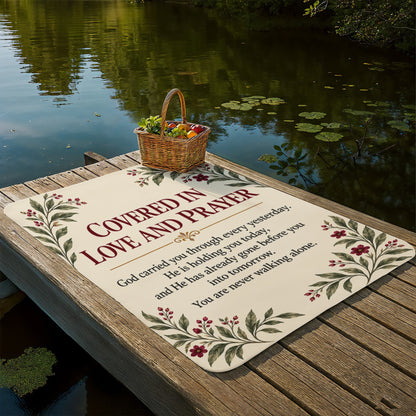 Christian encouragement blanket displayed outdoors by a peaceful lake